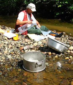David Strain preparing sample bags for the collection of heavy mineral stream sediment samples in the Eskay Creek area, British Columbia
