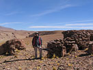 Geologist Jay Page examining rhyolitic bedrock in the Cerro Galan area, Argentina
